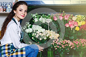 People, business, sale and floristry concept - happy smiling florist photo