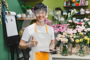 People, business, technology, sale and floristry and concept - happy smiling florist man with tablet pc computer at flower shop