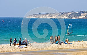 People on busy active kitesurfing beach in Spain