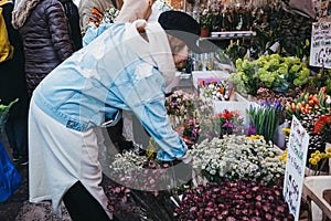 People buying flowers at Columbia Road Flower Market, London, UK