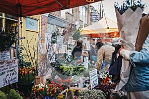 People buying flowers at Columbia Road Flower Market, London, UK