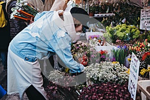 People buying flowers at Columbia Road Flower Market, London, UK