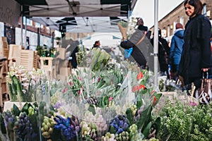 People buying flowers at Columbia Road Flower Market, London, UK