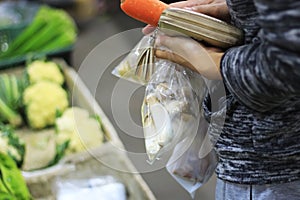 People are buying food in the market.