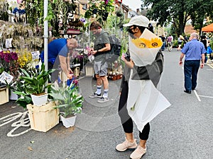 People buying plants at the Columbia road flower market London , Uk