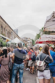 People buying plants and flowers at the Columbia Road Flower Market, London, UK.