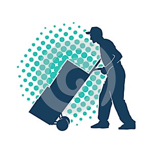 Silhouette of a male worker pushing lori wheels transporting carboard boxes. photo