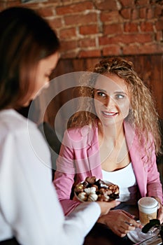 People At Cafe. Waitress Serving Female Client