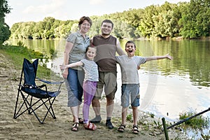 People camping and fishing, family active in nature, fish caught on bait, river and forest, summer season