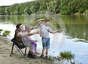 People camping and fishing, family active in nature, fish caught on bait, river and forest, summer season