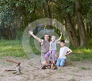 People camping in forest, family active in nature, kindle fire, summer season