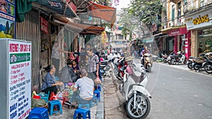 People can seen having their food beside the street in the morning at Hanoi, Vietnam.