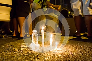 People with candle vigil in darkness seeking hope, worship, pray
