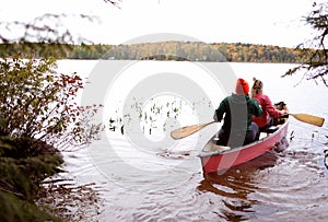 People are canoeing on a peaceful body of water