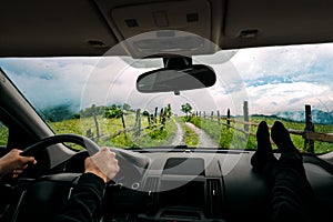 People in car traveling on countryside road