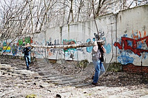 People carry tree trunk during cleaning works at photo