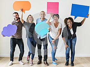 People carrying speech bubble icons