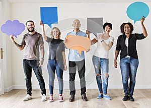 People carrying speech bubble icons