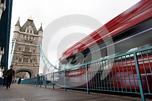 People and cars moving fast over the Tower Bridge