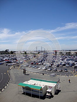 People and cars in Oakland-Alameda County Coliseum Parking Lot