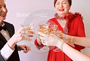 people celebrating new year with glasses of white sparkling wine at the party