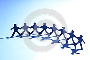 People in chain with heart between