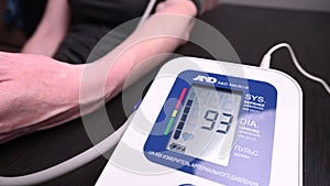 People checks the blood pressure at home. health care. pulse and heart rate.