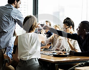 People cheers a wine glasses together