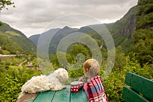 People, children enjoying the amazing views in Norway to fjords, mountains and beautiful nature miracles, having breakfast while