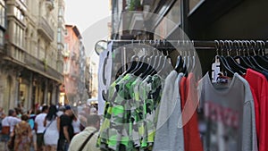 People choosing low priced t-shirts on street shopping stalls at local bazaar