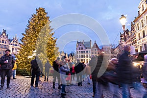 People at the Christmas market in Grote Markt square in Antwerp, Belgium at dusk