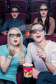 People in the cinema wearing 3d glasses