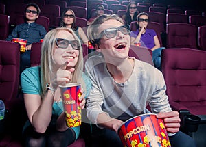 People in the cinema wearing 3d glasses