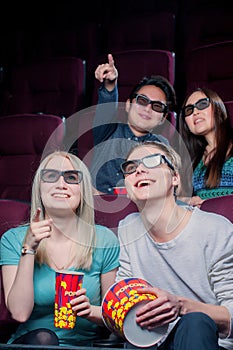 People in the cinema wearing 3d glasses