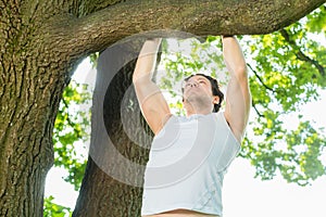 People in city park doing chins or pull ups