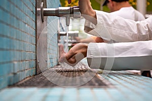 People cleaning hands and using tap water in a kitchen sink.