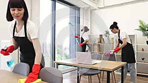 People of cleaning service cleans tables, floor, and panoramic windows.