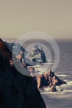 People on a cliff above the sea on a cloudy gloomy day, Cabo da roca, defocused
