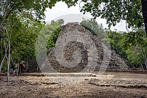 People climb and descend from the pyramid