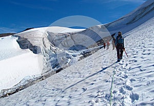 People climbers, climbing snow summit, rocky mountain peaks and glacier in Norway