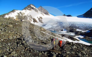 People climbers, climbing to the summit, rocky mountain peaks and glacier in Norway