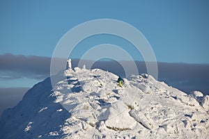 People climbing to the top of snowed mountains peak