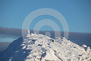 People climbing to the top of snowed mountains peak