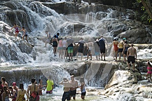 People climbing up Dunn`s River Falls, Jamaica