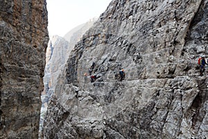 People climbing the Via Ferrata Sentiero delle Bocchette Alte in Brenta Dolomites mountains, Italy
