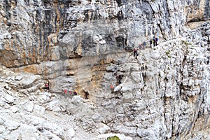 People climbing on via ferrata Sentiero delle Bocchette Centrale in Brenta Dolomites mountains, Italy