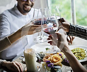 People Clinging Wine Glasses Together in Restaurant photo