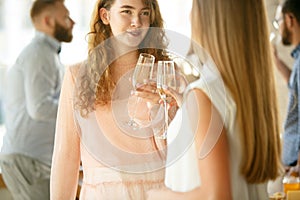 People clinking glasses with wine or champagne. Happy cheerful friends celebrate holidays, meeting. Close up shot of