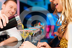 People in club or bar drinking cocktails