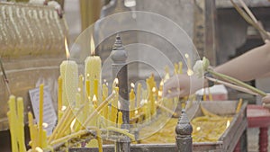 People come to pay respect to monks by burning incense sticks and candles for blessing on the holy